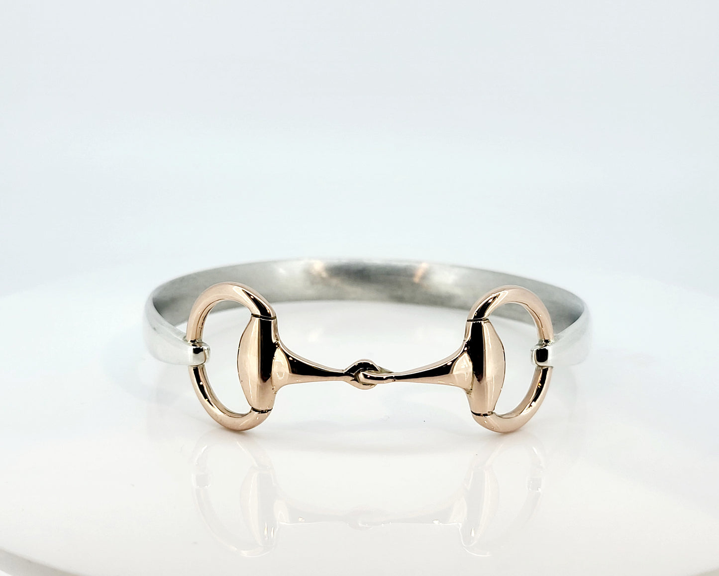 The two tone snaffle bangle. The snaffle is a solid 9ct rose gold, and the band in sterling silver.