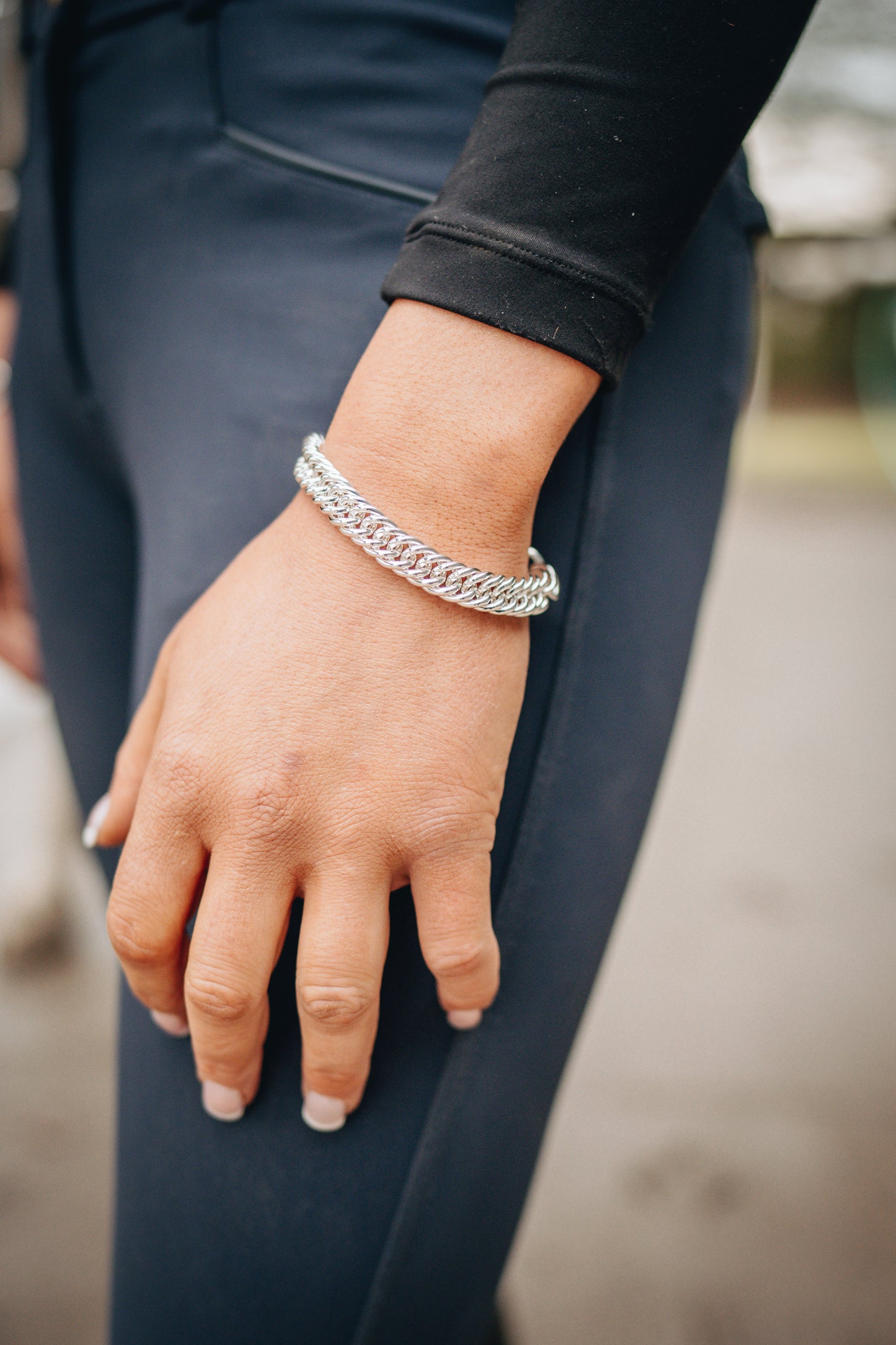 An equestrian wearing the original Crawford Hill Curb Chain bracelet