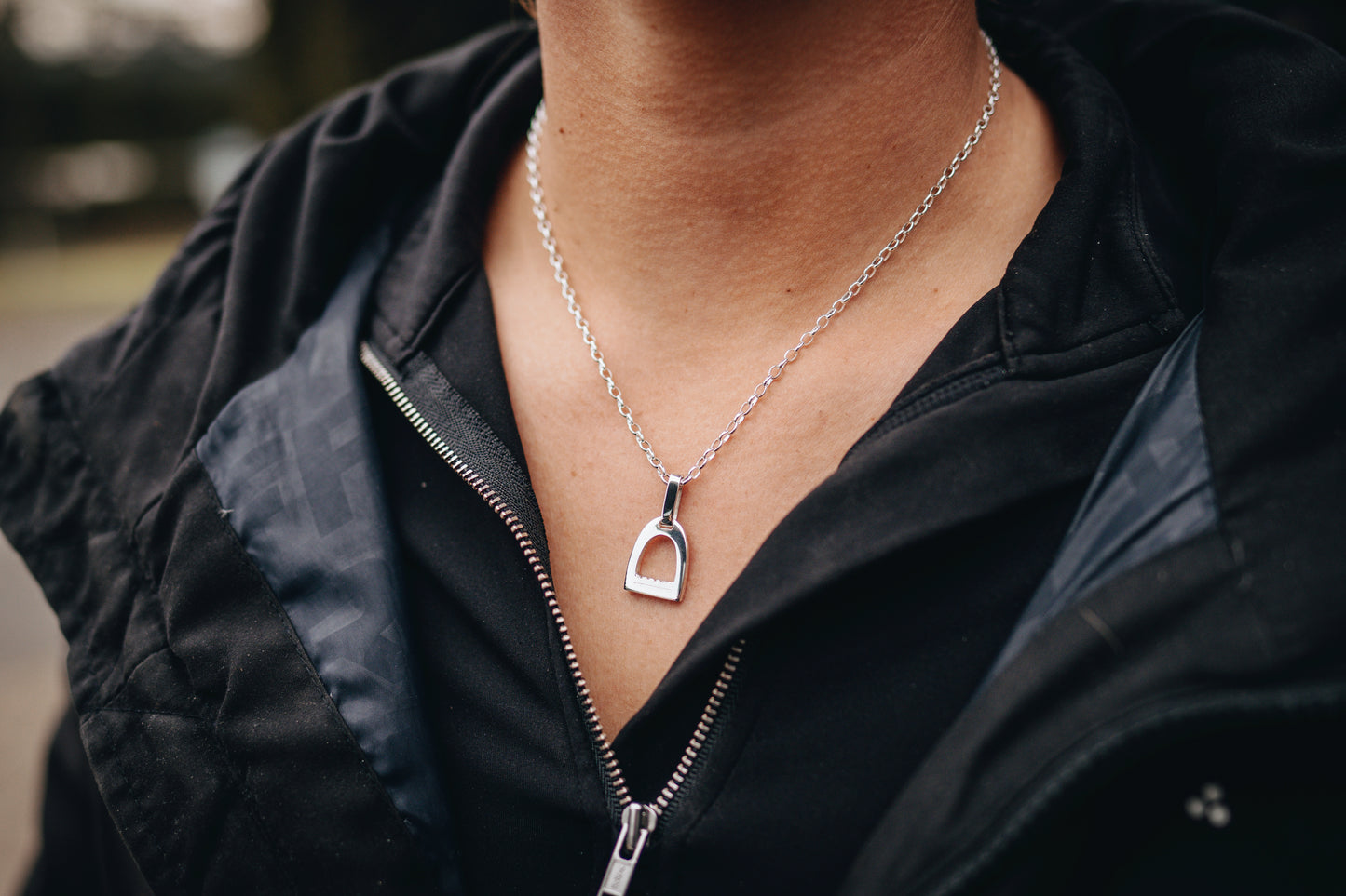 Small sterling silver stirrup pendant on a fine oval belcher chain
