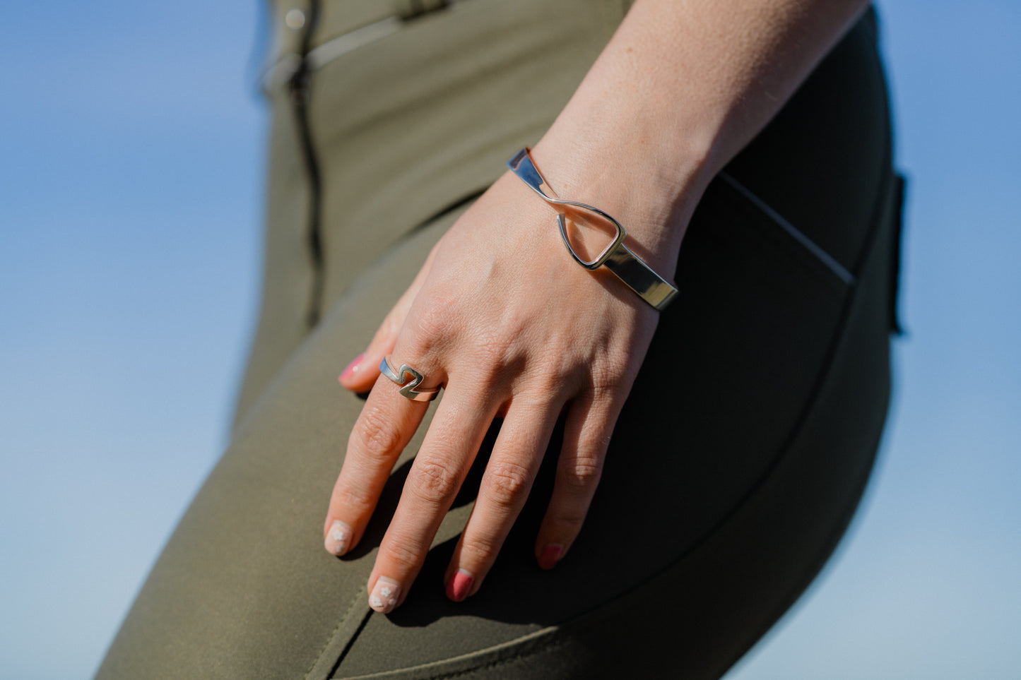 An equestrian wearing the popular Jump Stirrup Bangle. The bangle is designed to pay homage to the iconic Free Jump Stirrup. With a cool twist in the band.