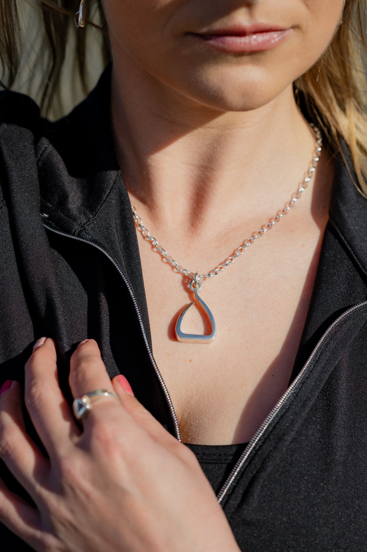 Another version of the Jump stirrup pendant. A little more casual, with a ring bale in sterling silver worn on a medium weight sterling silver oval belcher chain.