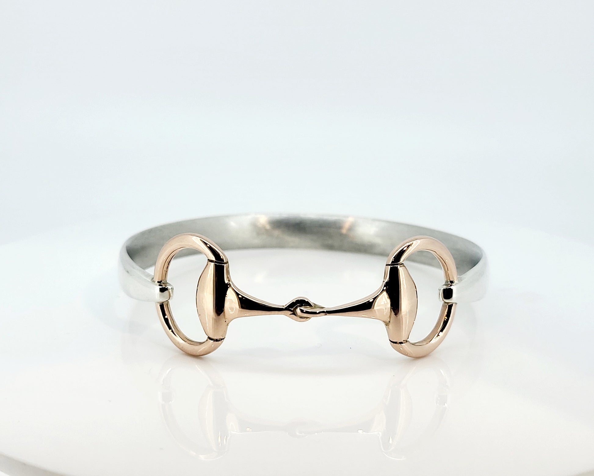 The two tone snaffle bangle. The snaffle is a solid 9ct rose gold, and the band in sterling silver. 