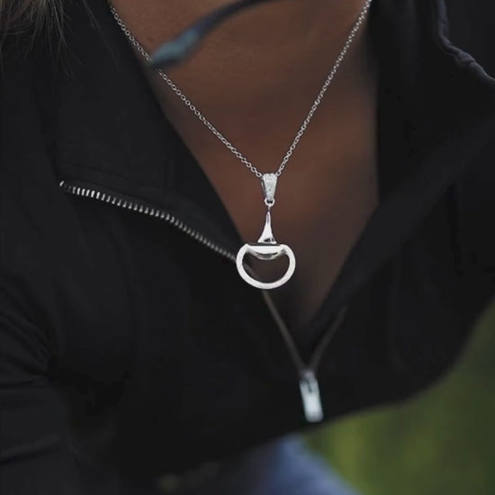 Video of an equestrian horse rider earing a white gold, diamond set half snaffle pendant by Crawford Hill Equestrian Jewellery. 