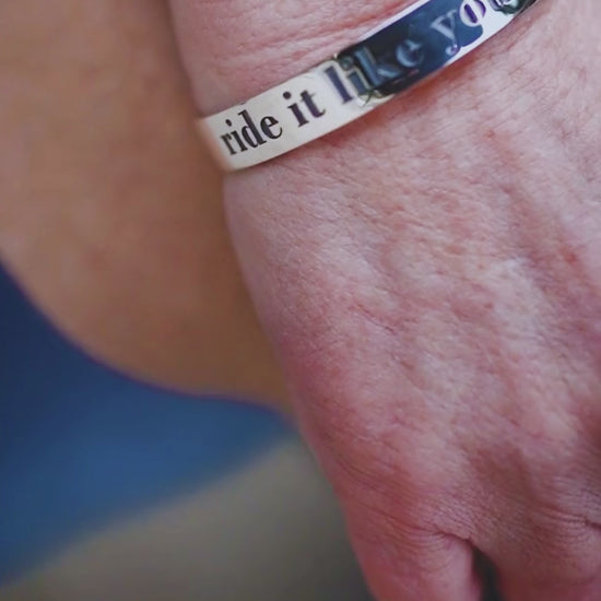 Ride it like you stole it bangle worn by a horse rider. By Crawford hill Equestrian Jewellery